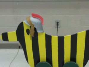 tiger striped wooden duck with roman helmet